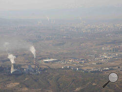 FILE - Smoke and steam rise from towers at the coal-fired Urumqi Thermal Power Plant in Urumqi in western China's Xinjiang Uyghur Autonomous Region on April 21, 2021. Global carbon pollution this year has bounced back to almost 2019 levels, after a drop during pandemic lockdowns. A new study by climate scientists at Global Carbon Project finds that the world is on track to put 36.4 billion metric tons of invisible carbon dioxide. (AP Photo/Mark Schiefelbein, File)