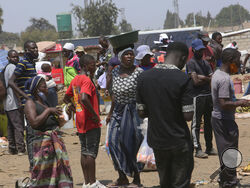 People are seen at a busy market in a poor township on the outskirts of the capital Harare, Monday, Nov, 15, 2021. When the coronavirus first emerged last year, health officials feared the pandemic would sweep across Africa, killing millions and destroying the continent’s fragile health systems. Although it’s still unclear what COVID-19’s ultimate toll will be, that catastrophic scenario has yet to materialize in Zimbabwe or much of Africa. (AP Photo/Tsvangirayi Mukwazhi)