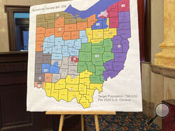 FILE—A map of Ohio congressional districts sits on display during a committee hearing at the Ohio Statehouse in Columbus, Ohio in this file photo from Nov. 16, 2021. On Friday, Jan. 14, 2022, the Ohio Supreme Court rejected a new map of the state's 15 congressional districts as gerrymandered, sending the blueprint back for another try. The 4-3 decision returns the process to the powerful Ohio Redistricting Commission. (AP Photo/Julie Carr Smyth, File)