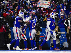 Buffalo Bills running back Devin Singletary, second from left, celebrates his touchdown with his teammates during the first half of an NFL wild-card playoff football game against the New England Patriots, Saturday, Jan. 15, 2022, in Orchard Park, N.Y. (AP Photo/Adrian Kraus)
