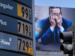 Gas prices are seen in front of a billboard advertising HBO's Last Week Tonight in Los Angeles, Monday, March 7, 2022. The price of regular gasoline broke $4 per gallon on average across the U.S. on Sunday for the first time since 2008. (AP Photo/Jae C. Hong)