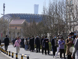 Residents line up for COVID test on Monday, March 14, 2022, in Beijing. Chinese authorities reported more than 1,300 locally transmitted cases of COVID-19 across dozens of mainland cities Monday as the fast-spreading variant commonly known as "stealth omicron" fuels China's biggest outbreak in two years. (AP Photo/Ng Han Guan)