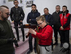 Ukrainian civilians receive weapons training in Lviv, Western Ukraine, Saturday, March 19, 2022. Fighting raged on multiple fronts in Ukraine more than three weeks after Russia's Feb. 24 invasion. U.N. bodies have confirmed more than 800 civilian deaths since the war began but say the real toll is considerably higher. The U.N. says more than 3.3 million people have fled Ukraine as refugees. (AP Photo/Bernat Armangue)