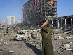 A priest prays by the ruins of a destroyed shopping center after shelling, in Kyiv, Ukraine, Monday, March 21, 2022. (AP Photo/Efrem Lukatsky)