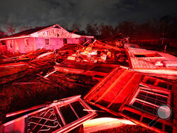 Destroyed homes, illuminated by fire engine lights, are seen after a tornado struck the area in Arabi, La., Tuesday, March 22, 2022. A tornado tore through parts of New Orleans and its suburbs Tuesday night, ripping down power lines and scattering debris in a part of the city that had been heavily damaged by Hurricane Katrina 17 years ago. (AP Photo/Gerald Herbert)