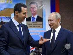 FILE - Syrian President Bashar Assad, left, gestures while speaking to Russian President Vladimir Putin during their meeting in Damascus, Syria, Jan. 7, 2020. The next chapter of the war in Ukraine could see Russia bringing in greater numbers of battle-hardened fighters from Syria, observers say. (Alexei Druzhinin, Sputnik, Kremlin Pool Photo via AP, File)