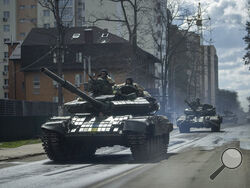 Ukrainian tanks move in a street in Irpin, in the outskirts of Kyiv, Ukraine, Monday, April 11, 2022. (AP Photo/Evgeniy Maloletka)