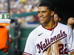 FILE - Washington Nationals' Juan Soto smiles in the dugout after a solo home run during a baseball game against the New York Mets at Nationals Park, Monday, Aug. 1, 2022, in Washington. the Nationals on Tuesday, Aug. 2, 2022, in one of baseball's biggest deals at the trade deadline, vaulting their postseason chances by adding a World Series champion who is one of baseball’s best hitters in his early 20s. A person with direct knowledge of the move told The Associated Press the Padres and Nationals have agre