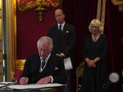 King Charles III signs an oath to uphold the security of the Church in Scotland during the Accession Council at St James's Palace, London, Saturday, Sept. 10, 2022, where King Charles III is formally proclaimed monarch. (Victoria Jones/Pool Photo via AP)