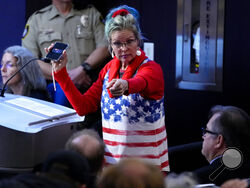 A woman points at Maricopa County Recorder Stephen Richer during the Maricopa County Board of Supervisors general election canvass meeting, Monday, Nov. 28, 2022, in Phoenix. (AP Photo/Matt York)