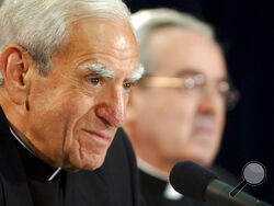 FILE - Cardinal Anthony Bevilacqua listens to a reporter's question as Archbishop Justin F. Rigali, right, listens at a news conference in Philadelphia, July 15, 2003. Monsignor William Lynn, the longtime secretary for clergy, was accused of sending a known predator, named on a list of problem priests he had prepared for Cardinal Bevilacqua, to an accuser’s northeast Philadelphia parish. Lynn served nearly three years in state prison before appeals courts threw out his felony child endangerment conviction, 