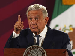 FILE - Mexico's President Andres Manuel Lopez Obrador speaks during his daily press conference at the National Palace, in Mexico City, Wednesday, June 22, 2022. Lopez Obrador appealed to the country’s citizens Tuesday, Dec. 27, not to accept holiday handouts and gifts from drug gangs, after videos posted online showed garish pickup trucks handing out loads of gifts while bystanders described the drivers as members of the Jalisco drug cartel. (AP Photo/Marco Ugarte, File)