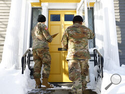 National guard members check on residents, Wednesday, Dec. 28, 2022, in Buffalo N.Y., following a winter storm. The National Guard went door to door in parts of Buffalo on Wednesday to check on people who lost power during the area’s deadliest winter storm in decades, and authorities faced the tragic possibility of finding more victims amid melting snow. (AP Photo/Jeffrey T. Barnes)