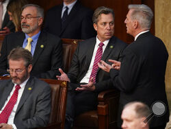 Rep. Kevin McCarthy, R-Calif., right, talks with Rep. Andy Ogles, R-Tenn., during the eighth round of voting in the House chamber as the House meets for the third day to elect a speaker and convene the 118th Congress in Washington, Thursday, Jan. 5, 2023. (AP Photo/Alex Brandon)