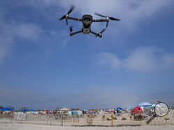 A drone is flown in for a landing after a shark patrol flight at Jones Beach State Park, Thursday, July 6, 2023, in Wantagh, N.Y. Drones are sweeping over the ocean off the coast of New York’s Long Island to patrol the waters for any danger possibly lurking. (AP Photo/John Minchillo)