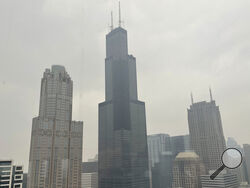 FILE - The Willis Tower (formerly Sears Tower) is pictured in downtown Chicago, where the air quality has been categorized "unhealthy" by the U.S. Environmental Protection Agency, on June 27, 2023. The EPA says extensive swaths of the northern United States awoke to unhealthy air quality Monday, July 17, or were experiencing it by midafternoon. Fine particle pollution caused by smoke from Canada’s wildfires is causing a red zone air quality index, meaning it is unhealthy for everyone. (AP Photo/Claire Savag