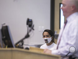 Jessica Nunez, the mother of a girl who went missing days before her 15th birthday in 2019, listens as Glendale police Sgt. Patrick Beaumler speaks during a press conference on the first anniversary of her daughter's disappearance on Sept. 15, 2020, at Glendale Regional Public Safety Training Center in Glendale, Ariz. Authorities announced Wednesday, July 26, 2023, that Nunez's daughter walked into a small-town police station in Montana this week. (The Arizona Republic via AP)
