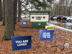 FILE - Signs stand outside Richneck Elementary School in Newport News, Va., on Jan. 25, 2023. The mother a 6-year-old who shot his teacher in Virginia is expected to plead guilty Tuesday, Aug. 15, 2023, seven months after her son used her handgun in the classroom shooting. (AP Photo/Denise Lavoie, File)