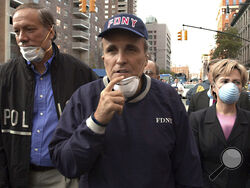 FILE — New York Mayor Rudolph Giuliani, center, leads New York Gov. George Pataki, left, and Sen. Hillary Rodham Clinton, D-N.Y., on a tour of the site of the World Trade Center disaster, Sept. 12, 2001. Giuliani, once warmly regarded as "America's Mayor" in the wake of the 9/11 attacks, and who first rose to prominence as a federal prosecutor going after mobsters with a then-novel approach to racketeering cases, has seen his reputation tumble and his liberty threatened in defense of Donald Trump's bogus el