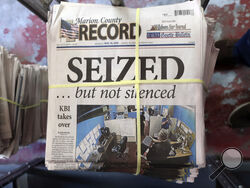 A stack of the latest weekly edition of the Marion County Record sits in the back of the newspaper's building, awaiting unbundling, sorting and distribution, Wednesday, Aug. 16, 2023, in Marion, Kan. The newspaper's front page was dedicated to two stories about a raid by local police on its offices and the publisher's home on Aug. 11, 2023. (AP Photo/John Hanna)