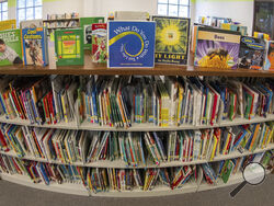 Books sit on shelves in an elementary school library in suburban Atlanta on Friday, 18, 2023. Although not new, book challenges have surged in public schools since 2020, part of a broader backlash to what kids read and discuss in school. (AP Photo/Hakim Wright Sr.)