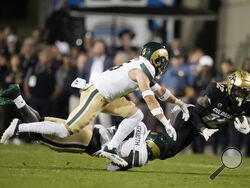 Colorado cornerback Travis Hunter (12) is dragged down after a short gain by Colorado State defensive back Henry Blackburn, back left, and defensive back Ayden Hector during the first half of an NCAA college football game Saturday, Sept. 16, 2023, in Boulder, Colo. (AP Photo/David Zalubowski)