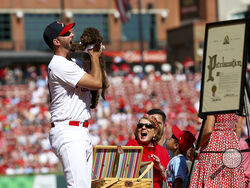 St. Louis Cardinals' Adam Wainwright is gifted a puppy as he is honored during his retirement ceremony before the Cardinals' final regular season baseball game Sunday, Oct. 1, 2023, against the Cincinnati Reds in St. Louis. (AP Photo/Scott Kane)