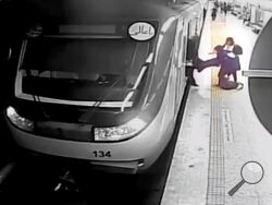 In this image from surveillance video aired by Iranian state television, women pull 16-year-old Armita Geravand from a train car on the Tehran Metro in Tehran, Iran, Sunday, Oct. 1, 2023. The mysterious injury suffered by Geravand not wearing a headscarf while boarding a Metro train in Iran's capital has reignited anger just after the one-year anniversary of the death of Mahsa Amini and the nationwide protests it sparked. (AP Photo/Iranian state television)