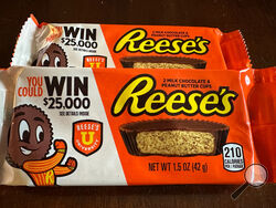 Two packages of Reese's candy featuring a sweepstakes ad are shown in Ann Arbor, MI., on Friday, Oct. 13, 2023. Reese's may be violating state and federal laws with the sweepstakes offer. (AP Photo/Dee-Ann Durbin)