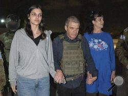 In this photo provided by the Government of Israel, Judith Raanan, right, and her 17-year-old daughter Natalie are escorted by Israeli soldiers and Gal Hirsch, Prime Minister Benjamin Netanyahu's special coordinator for returning the hostages, as they return to Israel from captivity in the Gaza Strip, Friday, Oct. 20, 2023. Hamas released the pair in what it said was a goodwill gesture late Friday, nearly two weeks after they were captured in a bloody cross-border raid by the Islamic militant group. The Ham