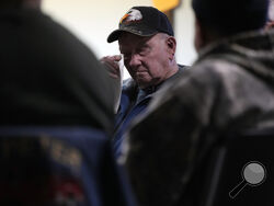 Earl Meyer, who fought for the U.S. Army in the Korean War, wipes away a tear while talking with fellow veterans at the American Legion, Tuesday, Nov. 7, 2023, in St. Peter, Minn. Meyer, 96, is suing the Army to try to get the Purple Heart medal that he says he earned when he was wounded during fierce combat in June of 1951. (AP Photo/Abbie Parr)