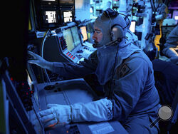 In this image provided by the U.S. Navy, Chief Fire Controlman (Aegis) Kenneth Krull, assigned to the USS Carney (DDG 64), mans the combat systems coordinator console in the combat information center during a general quarters drill on Oct. 14, 2023, in the Eastern Mediterranean. The warship sailing near the Bab el-Mandeb Strait shot down a drone launched from Yemen on Wednesday, Nov. 29, the U.S. military said, in the latest in a string of threats from Iranian-backed Houthi rebels. The USS Carney downed the