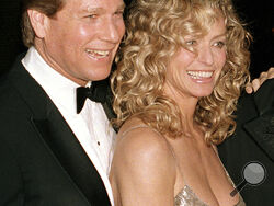 FILE - Actors Ryan O'Neal, left, and Farrah Fawcett are shown at the premiere of the film. "Chances Are," March 5, 1989, in New York. O’Neal, who was nominated for an Oscar for the tear-jerker “Love Story” and played opposite his precocious daughter Tatum in “Paper Moon,” has died. O’Neal's son Patrick said on Instagram that his father died Friday, Dec. 8, 2023. (AP Photo/Ray Stubblebine, File)