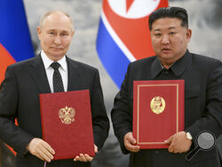 Russian President Vladimir Putin, left, and North Korea's leader Kim Jong Un pose for a photo during a signing ceremony of the new partnership in Pyongyang, North Korea, on Wednesday, June 19, 2024.
