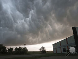 Severe storm clouds move across the northwest edge of Davenport, Iowa on Friday, May 24, 2024. Several tornadoes were reported in Iowa and Illinois as storms downed power lines and trees on Friday, just after a deadly twister devastated one small town.(Roy Dabner/Quad City Times via AP)