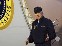 President Joe Biden walks down the steps of Air Force One at Dover Air Force Base in Delaware, Wednesday, July 17, 2024. Biden is returning to his home in Rehoboth Beach, Del., to self-isolate after testing positive for COVID-19. (AP Photo/Susan Walsh)