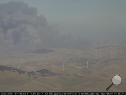 In this image from an AlertCalifornia/UC San Diego monitoring camera, smoke rises from the Corral Fire near the city of Tracy, Calif., Saturday, June 1, 2024. (AlertCalifornia/UC San Diego via AP)