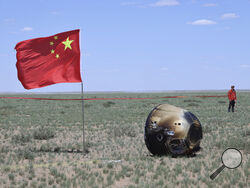 In this photo released by Xinhua News Agency, the return capsule of the Chang'e 6 probe is seen in Siziwang Banner, northern China's Inner Mongolia Autonomous Region on Tuesday, June 25, 2024. China's Chang'e 6 probe has returned on Earth with rock and soil samples from the little-explored far side of the moon in a global first. (Bei He/Xinhua via AP)