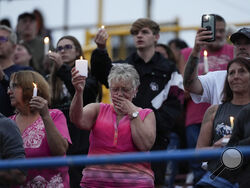 Family, friends and community attend a candlelight vigil for Corey Comperatore, the former fire chief shot and killed at a weekend rally for former President Donald Trump, Wednesday, July 17, 2024, at Lernerville Speedway in Sarver, Pa. (AP Photo/Eric Gay)