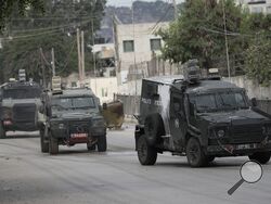 Israeli armoured vehicles move on a street during a military operation in the West Bank city of Jenin, Wednesday, Aug. 28, 2024. (AP Photo/Majdi Mohammed)