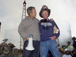 FILE — As rescue efforts continue in the rubble of the World Trade Center in New York, President George W. Bush, left, stands with New York City firefighter Bob Beckwith on a burnt fire truck in front of the World Trade Center during a tour of the devastation, Sept. 13, 2001. Beckwith, who became part of an iconic image of American unity after the Sept. 11 terrorist attacks, has died at age 91. The retired firefighter died Sunday night, Feb. 4, 2024, in hospice care after dealing with cancer in recent years