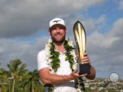 FILE -Grayson Murray holds the trophy after winning the Sony Open golf event, Sunday, Jan. 14, 2024, at Waialae Country Club in Honolulu. Two-time PGA Tour winner Grayson Murray died Saturday morning, May 25, 2024 at age 30, one day after he withdrew from the Charles Schwab Cup Challenge at Colonial(AP Photo/Matt York, File)