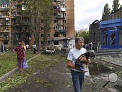 Residents of an apartment building damaged after shelling by the Ukrainian side leave the area in Kursk, Russia, Sunday, Aug. 11, 2024. (AP Photo)