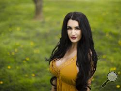 In this Tuesday, April 19, 2016, photo, law school student Candice Kashani poses for a photograph in Bryn Mawr, Pa. Kashani graduated from law school debt-free this spring, thanks to a modern twist on an age-old arrangement. (AP Photo/Matt Rourke)