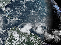 This National Oceanic and Atmospheric Administration satellite image taken at 4:20pm EDT shows hurricane Beryl, lower center right, as it strengthens over the Atlantic Ocean and churns toward the southeast Caribbean on Saturday, June 29, 2024. (NOAA via AP)