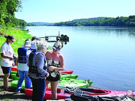 The residents of Maria Joseph Continuing Care Community in Danville get life vests on and prepare to get into kayaks at the Shady Nook Boat Access in Selinsgrove. The group boated 3 miles down the Susquehanna River on Friday.