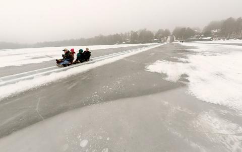 A toboggan cruises out across the frozen surface of Eagles Mere Lake as they reach the end of the 1,200 foot ice toboggan side which started at the top of Lake Ave Sunday afternoon. 