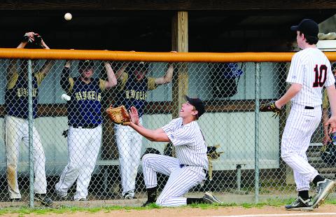 Benton third baseman Garret Watson, center, slides across the ground as he catches a foul ball off the bat of Northwest's Nick Long during Wednesday afternoon's game at Northwest. 