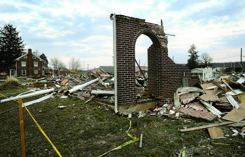 A front porch archway is all that is left standing of 920 W. Main St. as demolition work continued Tuesday on the Bloomsburg block ravaged by 2011's Lee Flood.