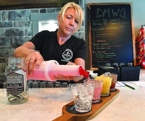 Denna Reed pours a flight of drinks Thursday evening at the Dead Man Walking Distillery along Route 11 in Montour Township. 